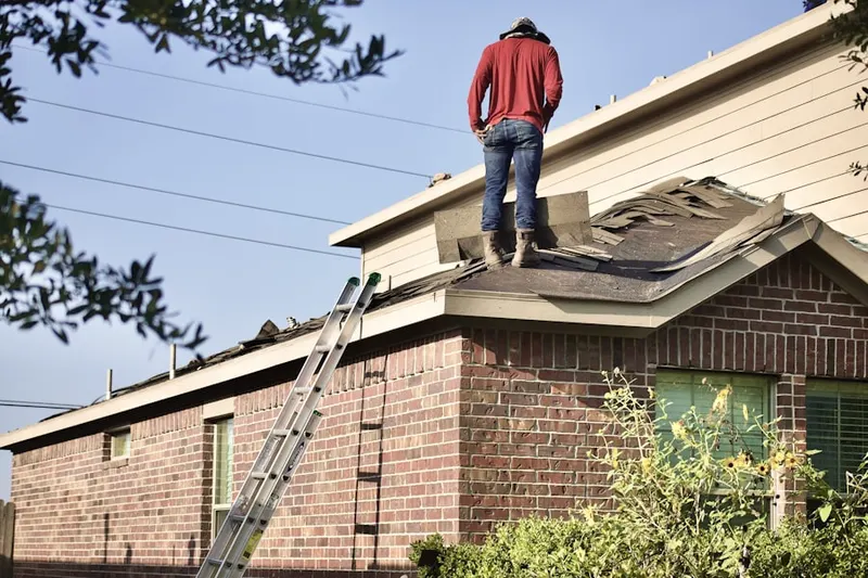 Professional roofer working on a residential roof in Baldwin Park